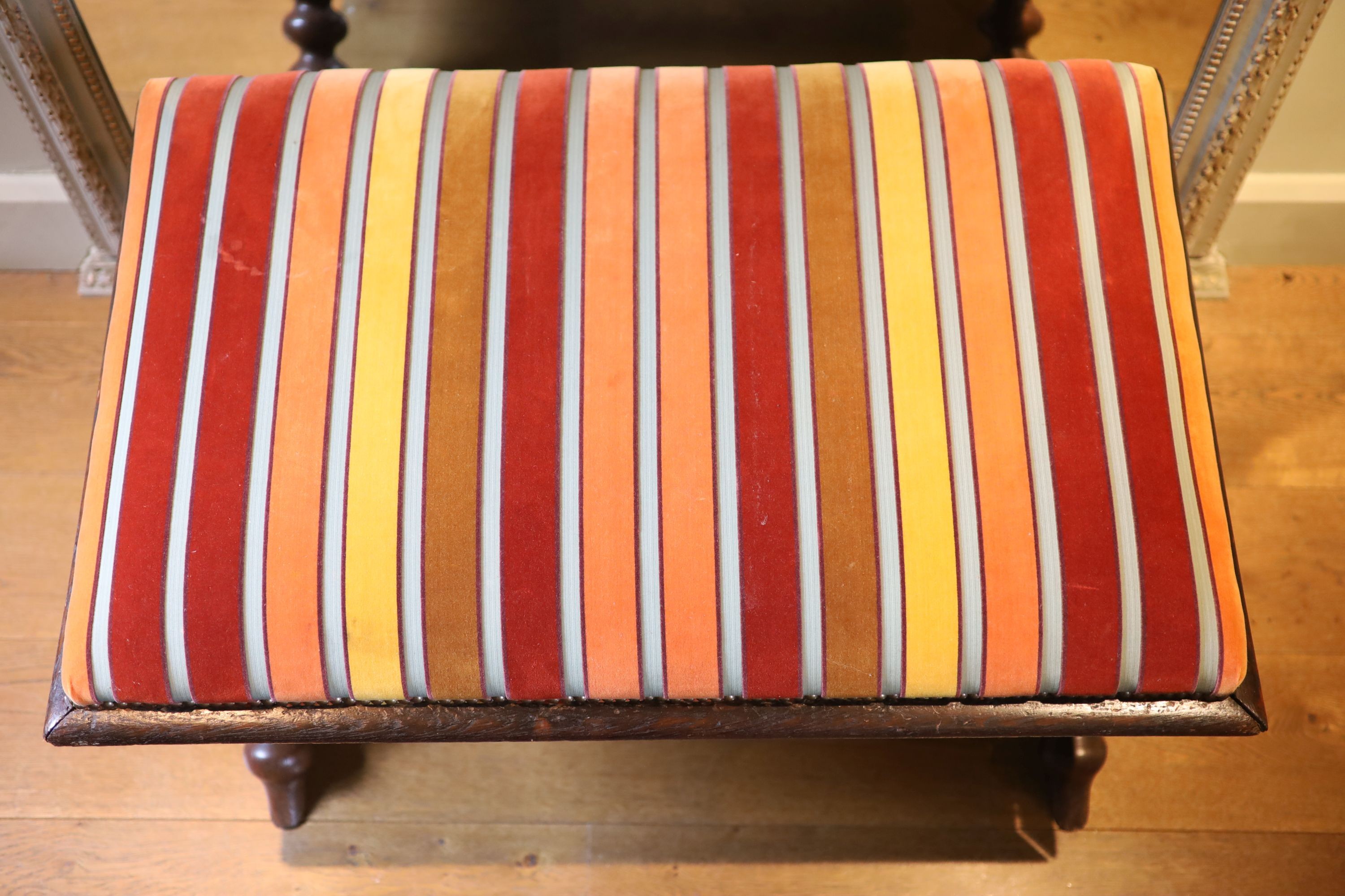 A Victorian stained oak stool, with striped upholstery and turned underframe, 90 x 60cm height 53cm